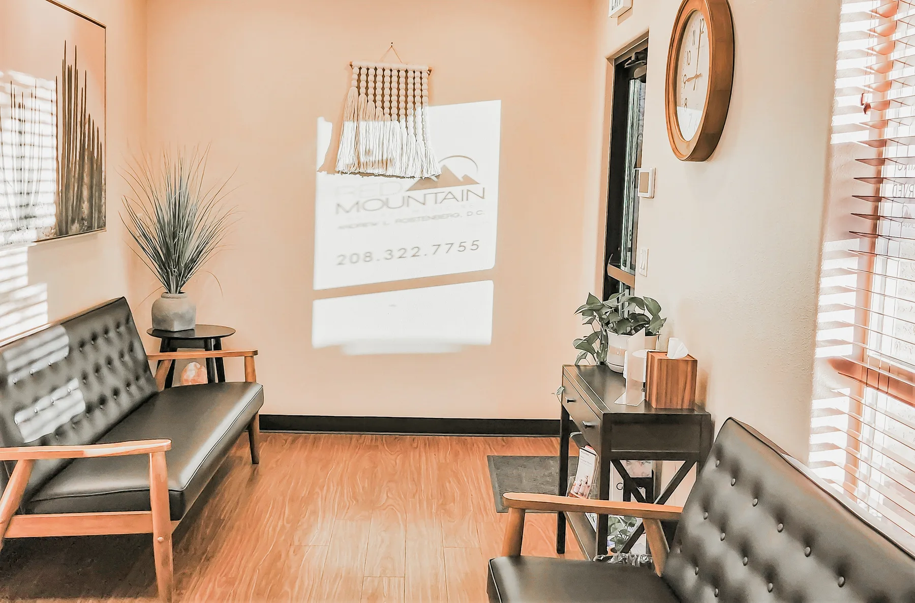 Walking in to Red Mountain Natural Medicine in Boise, Idaho — a calm, welcoming reception with the clinic's mountain logo on the wall